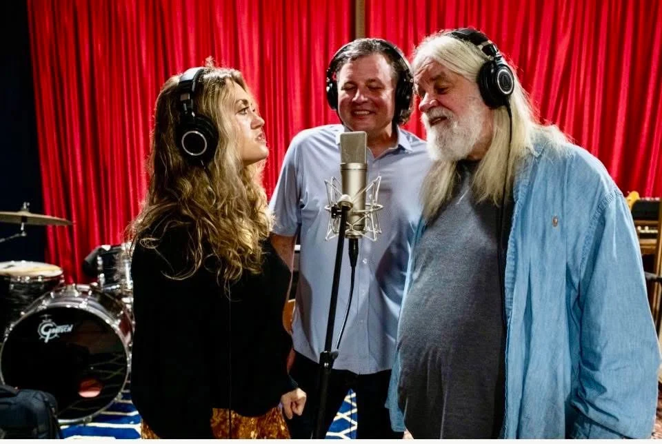 Jamie Dose singing in a recording studio with fellow musicians